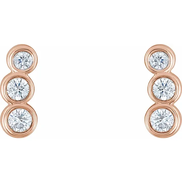 Front view of 14K rose gold petite ear climbers with three graduated natural diamonds