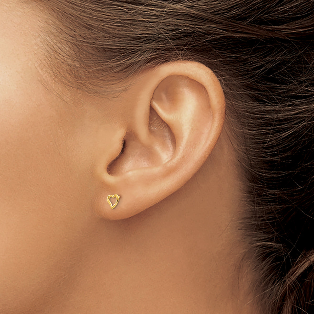 Children’s 14K yellow gold open heart stud earrings 5mm shown on ear