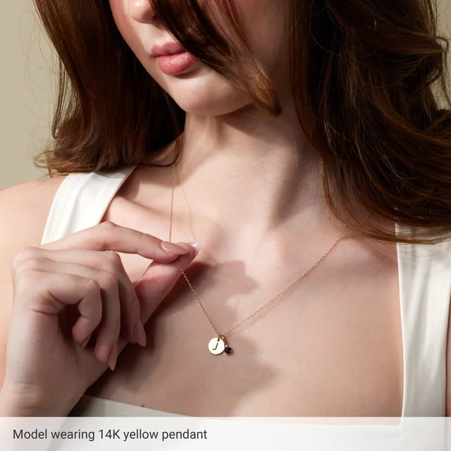 Initial disc necklace worn on model