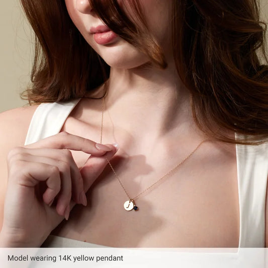 Initial disc necklace worn on model