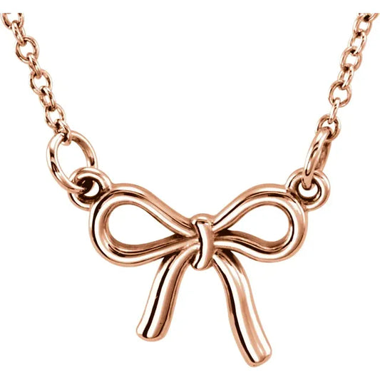 Tiny Posh knotted bow necklace in 14K rose gold, front view