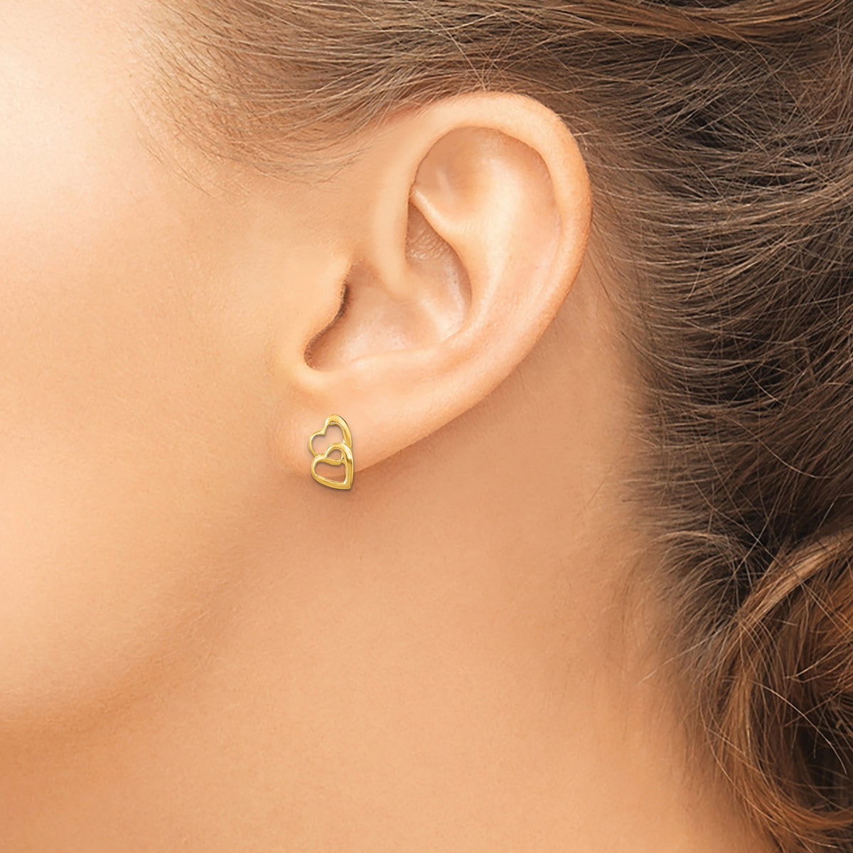 Petite 14K Gold Double Heart Stud Earrings shown on ear