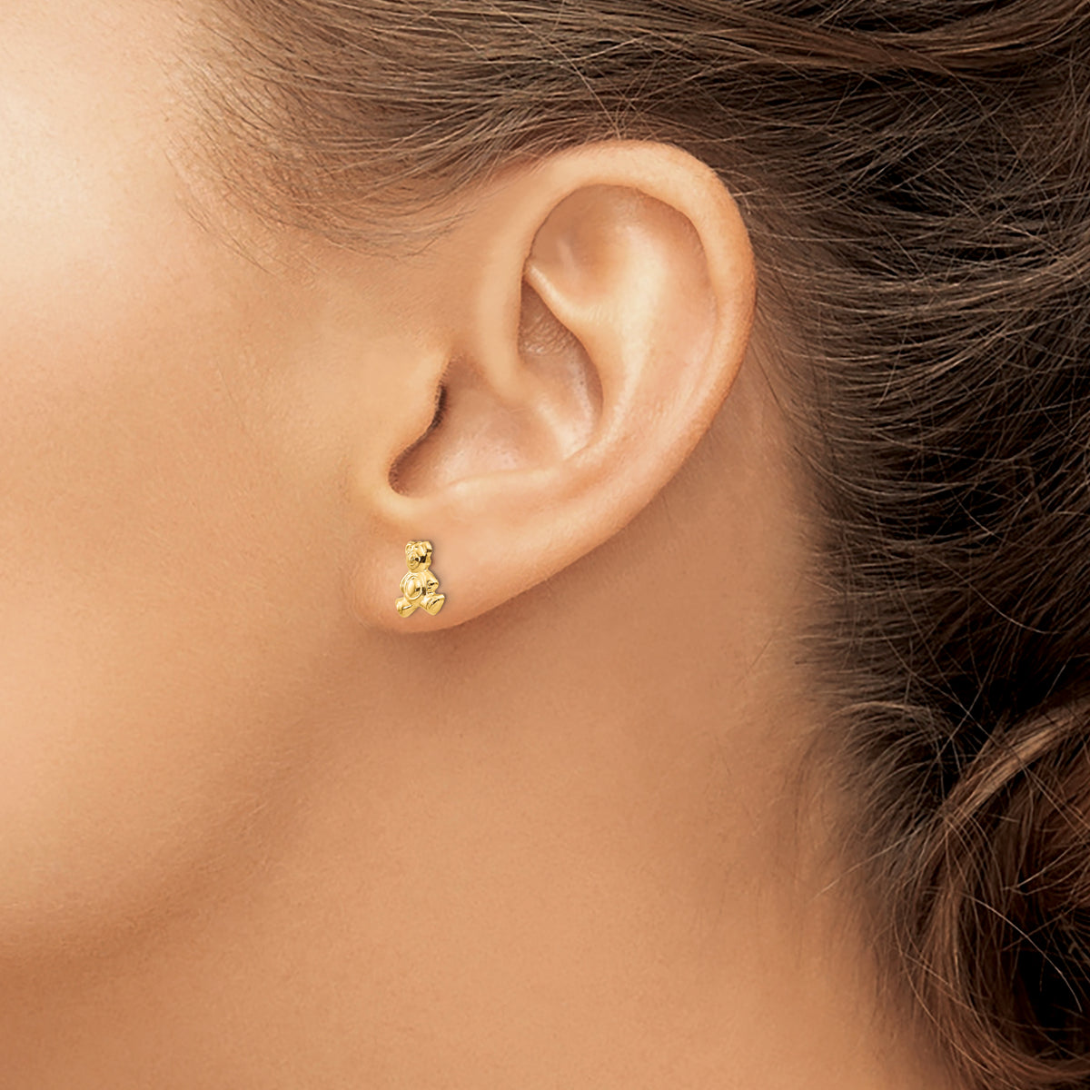 Children’s 14K yellow gold teddy bear earrings shown on ear