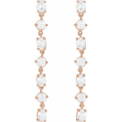 Front view of long alternating oval and round lab-grown diamond dangle earrings in 14K rose gold