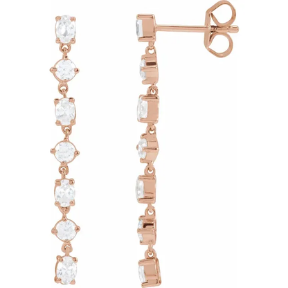Front and side view of alternating oval and round lab-grown diamond dangle earrings in 14K rose gold