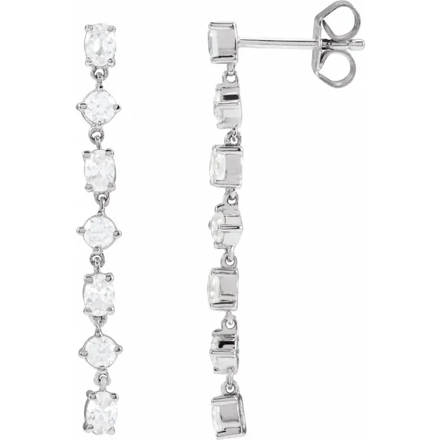 Front and side view of alternating oval and round lab-grown diamond dangle earrings in rhodium-plated 14K white gold