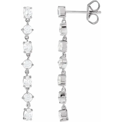 Front and side view of alternating oval and round lab-grown diamond dangle earrings in rhodium-plated 14K white gold