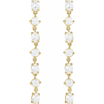 Front view of long alternating oval and round lab-grown diamond dangle earrings in 14K yellow gold