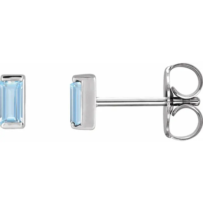 Lab-grown aqua sapphire baguette stud earrings in white metal, side view