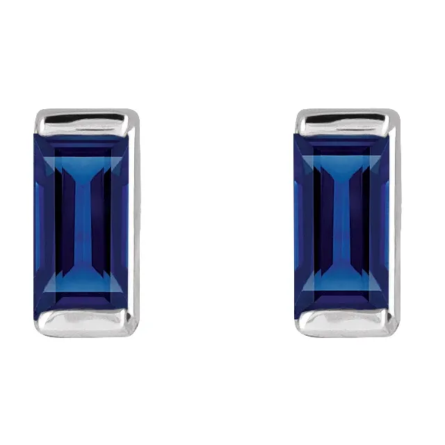 Lab-grown blue sapphire baguette stud earrings in white metal, front view