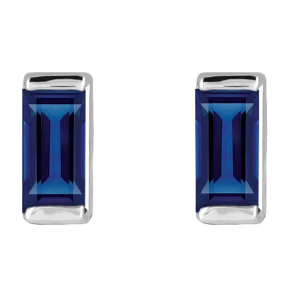 Lab-grown blue sapphire baguette stud earrings in white metal, front view