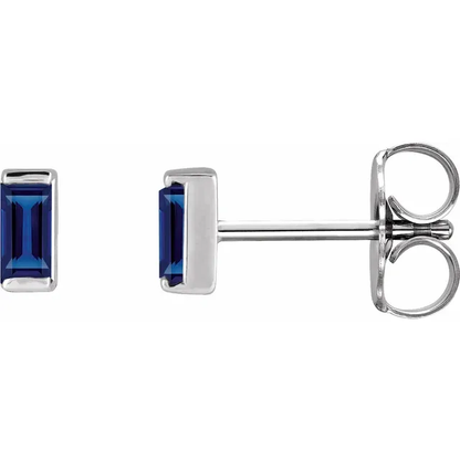 Lab-grown blue sapphire baguette stud earrings in white metal, side view