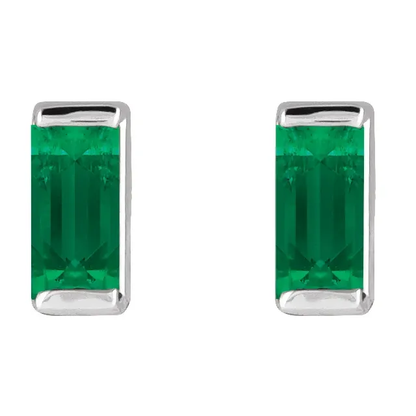 Lab-grown emerald baguette stud earrings in white metal, front view