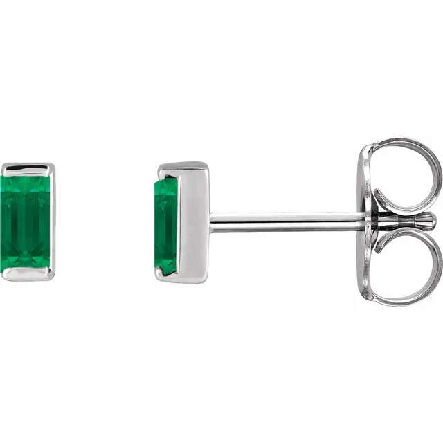 Lab-grown emerald baguette stud earrings in white metal, side view