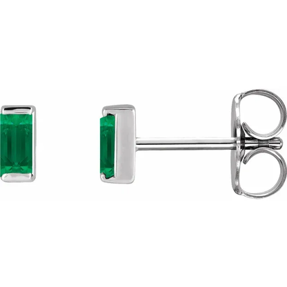 Lab-grown emerald baguette stud earrings in white metal, side view