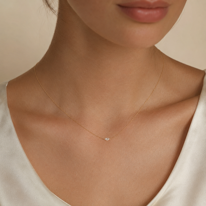 Model wearing the 1/4 CT marquise lab-grown diamond necklace in yellow gold