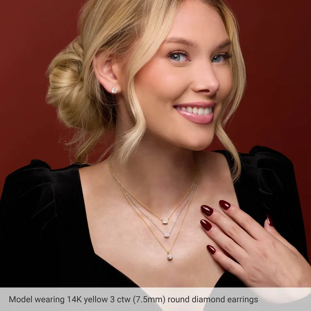 Model wearing 3 CTW round lab-grown diamond stud earrings in 14K yellow gold, approximately 7.5 mm