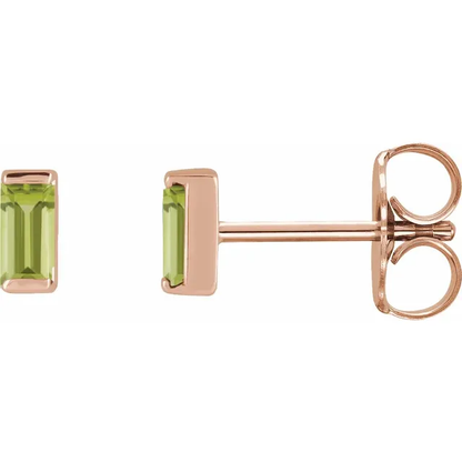 Natural peridot baguette stud earrings in 14K rose gold, side view