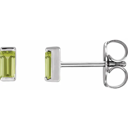 Natural peridot baguette stud earrings in white metal, side view
