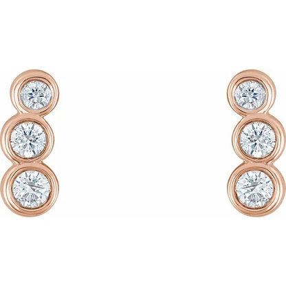 Front view of 14K rose gold petite ear climbers with three graduated natural diamonds