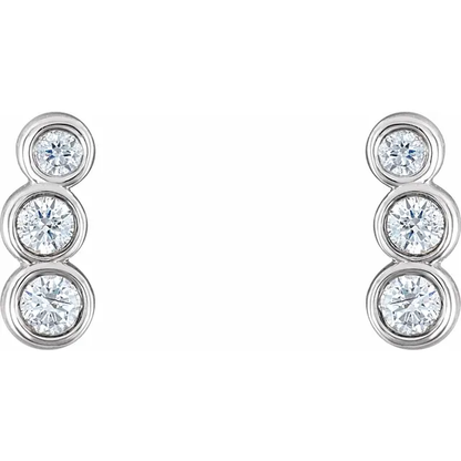 Front view of 14K white gold petite ear climbers with three graduated natural diamonds