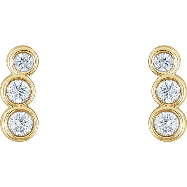Front view of 14K yellow gold petite ear climbers with three graduated natural diamonds