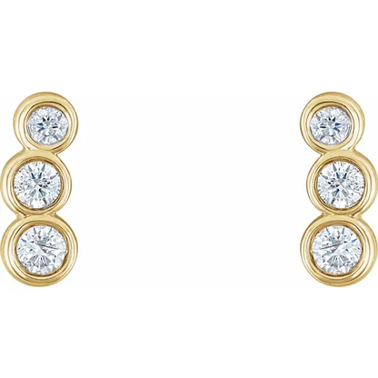 Front view of 14K yellow gold petite ear climbers with three graduated natural diamonds