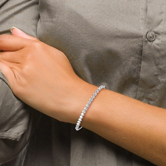 Silver-tone polished heart adjustable bolo bracelet shown on wrist