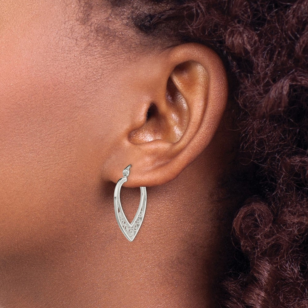 Sterling silver filigree heart hoop earrings worn on ear