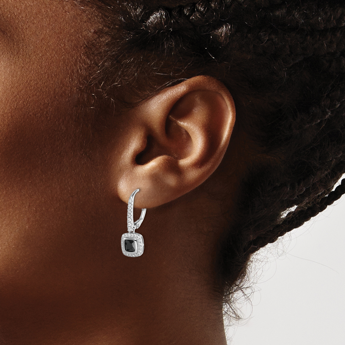 Sterling silver black and white CZ halo earrings worn on ear