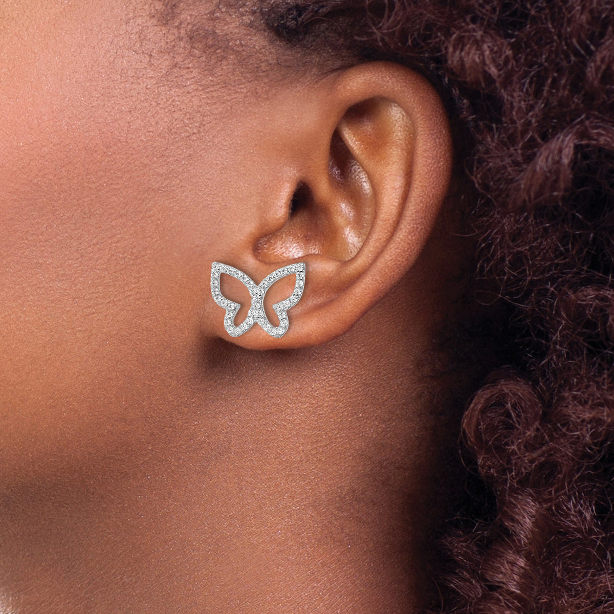 Sterling silver CZ butterfly stud earrings worn on ear