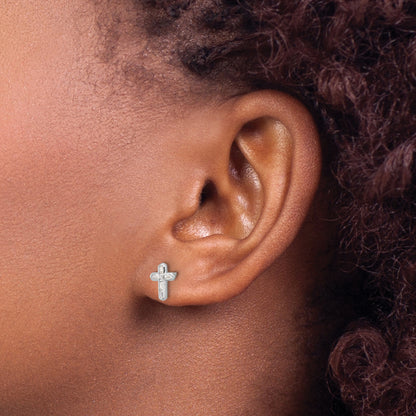 Sterling silver CZ cross stud earrings worn on ear