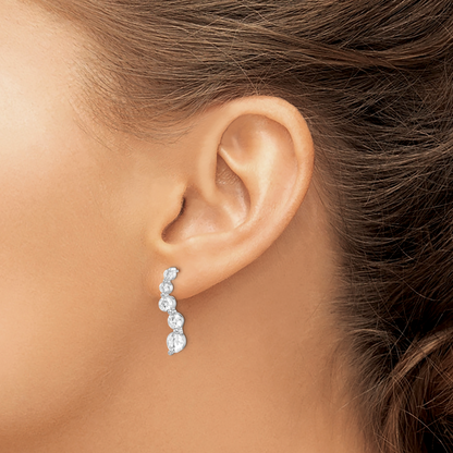 Sterling silver graduated CZ journey earrings worn on ear