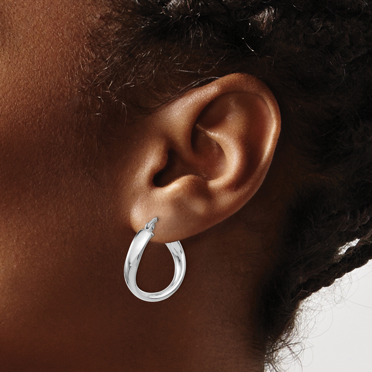Italian sterling silver twist hoop earrings worn on ear