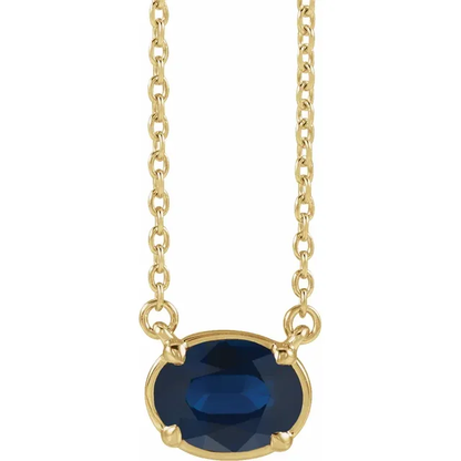 Front view of oval lab-grown blue sapphire necklace in 14K yellow gold vermeil