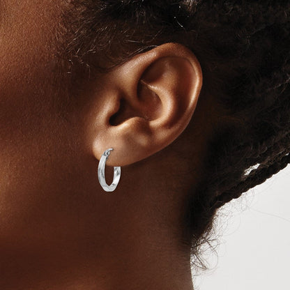 15 mm twisted hoop earrings shown on ear