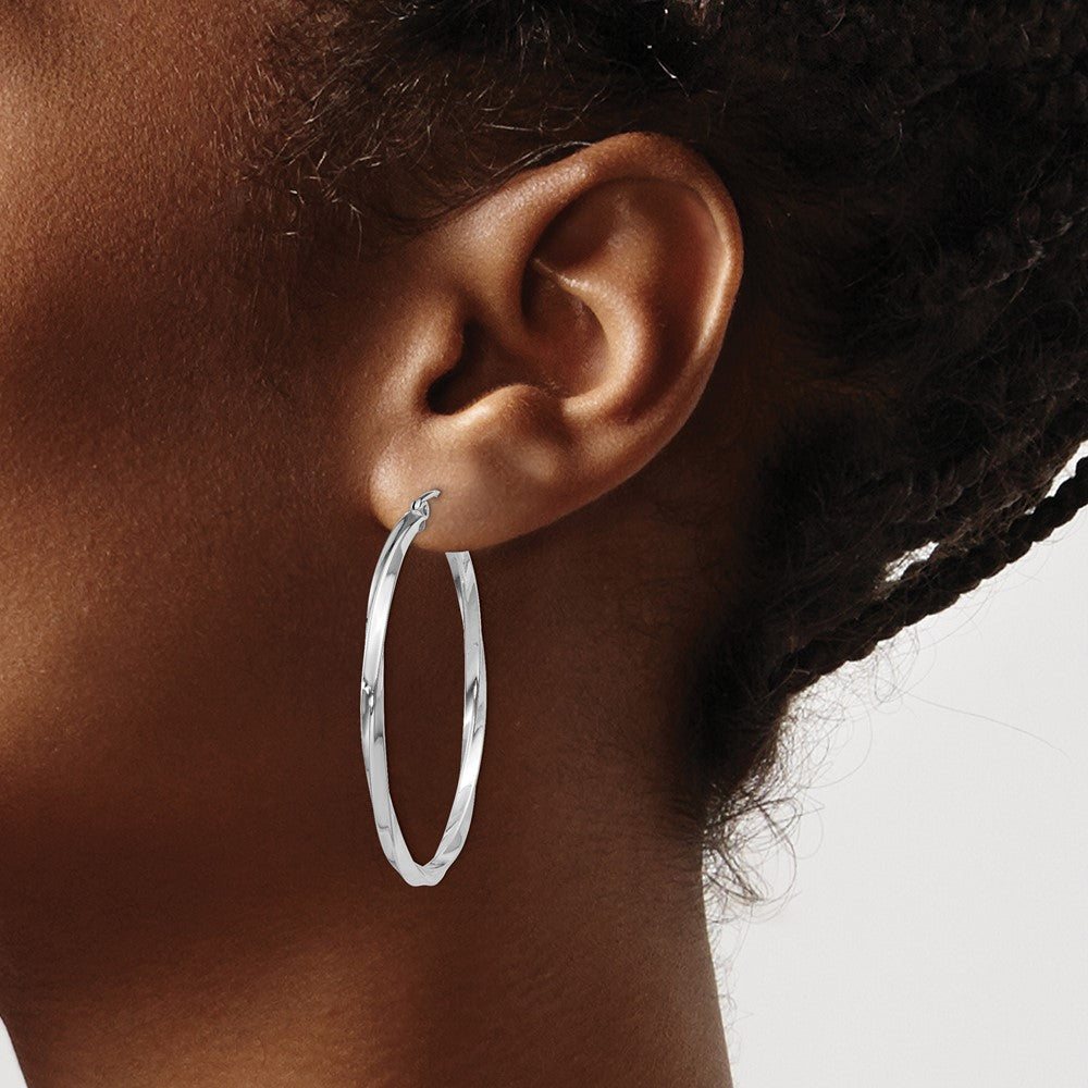 40 mm twisted hoop earrings shown on ear